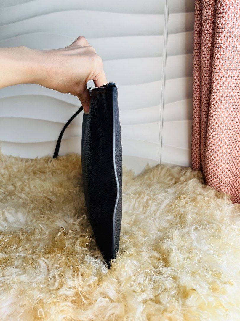 Michael Kors Black Leather Wristlet Clutch (Category: Clutches) located in Davao. Submitted by goodthingsph_ (Listing ID 1457342614, Image 2). Description: - Genuine black pebbled leather Michael Kors clutch 14x9” - Detachable wrist strap for versatility - Secure zip-around closure - Interior zip pocket and card slots for organization - Elegant silver-tone hardware - Ideal size for carrying your daily essentials.