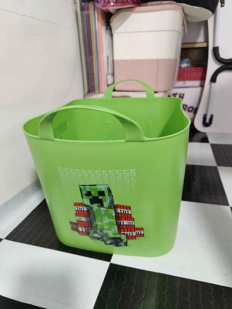 Minecraft Green Storage Bin with Handles (Category: Storage Boxes & Baskets) located in Makati City. Submitted by abegailbrezuela (Listing ID 1457385606, Image 2). Description: - Vibrant green storage bin featuring popular Minecraft characters (Creeper, Enderman, Steve). - Equipped with two sturdy handles for easy carrying and transport. - Ideal for organizing toys, books, craft supplies, and more. - A must-have for any young Minecraft enthusiast