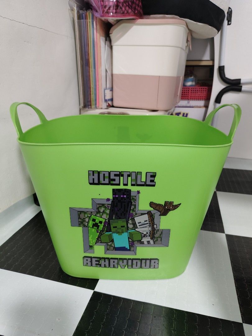 Minecraft Green Storage Bin with Handles (Category: Storage Boxes & Baskets) located in Makati City. Submitted by abegailbrezuela (Listing ID 1457385606, Image 1). Description: - Vibrant green storage bin featuring popular Minecraft characters (Creeper, Enderman, Steve). - Equipped with two sturdy handles for easy carrying and transport. - Ideal for organizing toys, books, craft supplies, and more. - A must-have for any young Minecraft enthusiast