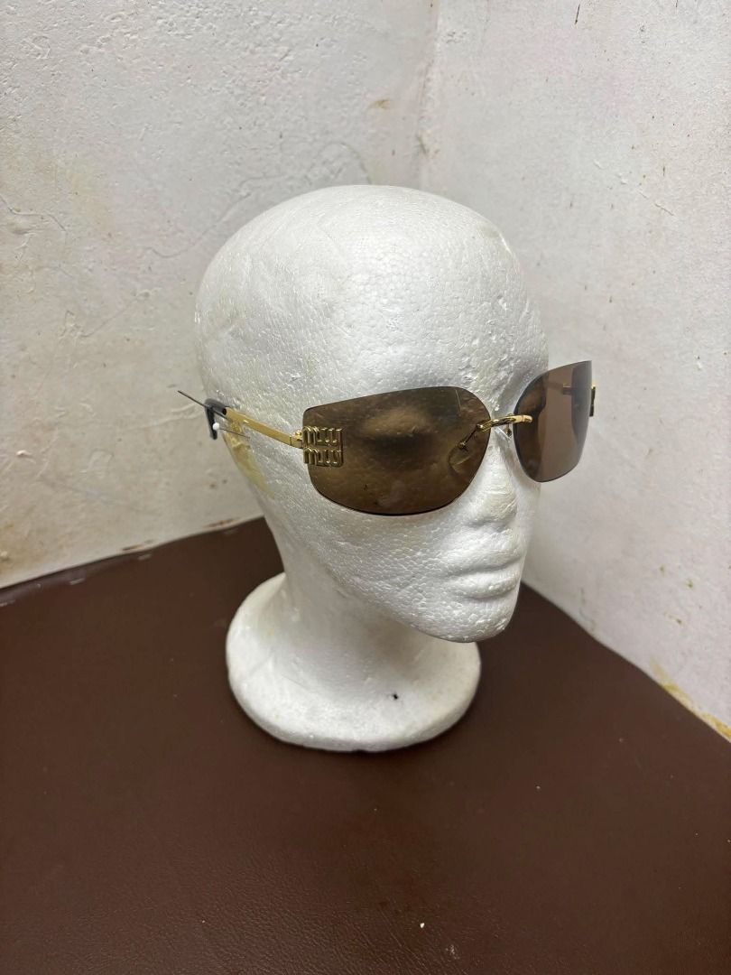 MIU MIU Aube sunglasses (Category: Sunglasses & Eyewear) located in Bacoor. Submitted by fafofa (Listing ID 1457498833, Image 2). Description: MIU MIU Aube sunglasses Metal sunglasses with a sophisticated, contemporary design. The ultra-light rimless style is characterized by the curved lenses embellished with the imposing vertical Miu Miu logo. Product code: SMU54Y_E5AK_FE30B_C_080 Metal frame front in Gold Frame not compatible with graduated le