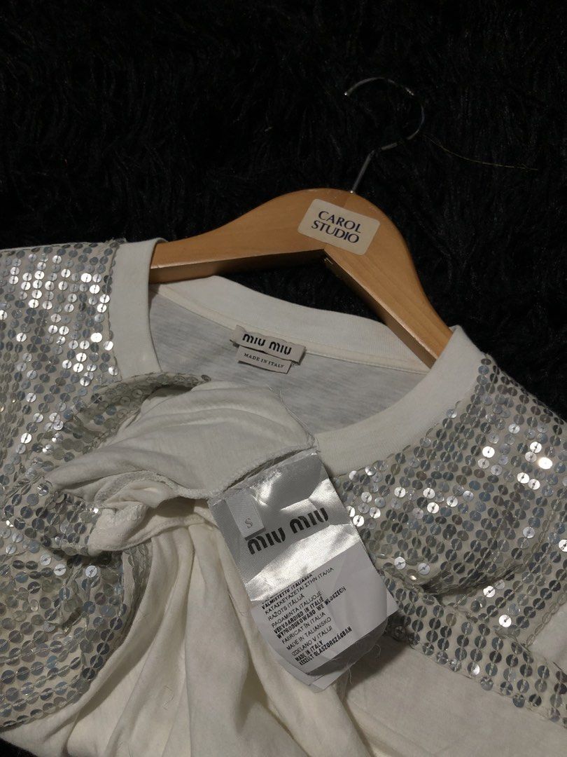 Miu Miu Sequin T-Shirt White (Category: Shirts) located in Munoz. Submitted by bb_jimbo0 (Listing ID 1457456411, Image 3). Description: - White Miu Miu T-shirt - Dazzling silver sequins covering the front - Short sleeves - Made in Italy - Size S - Versatile: dress up or down.