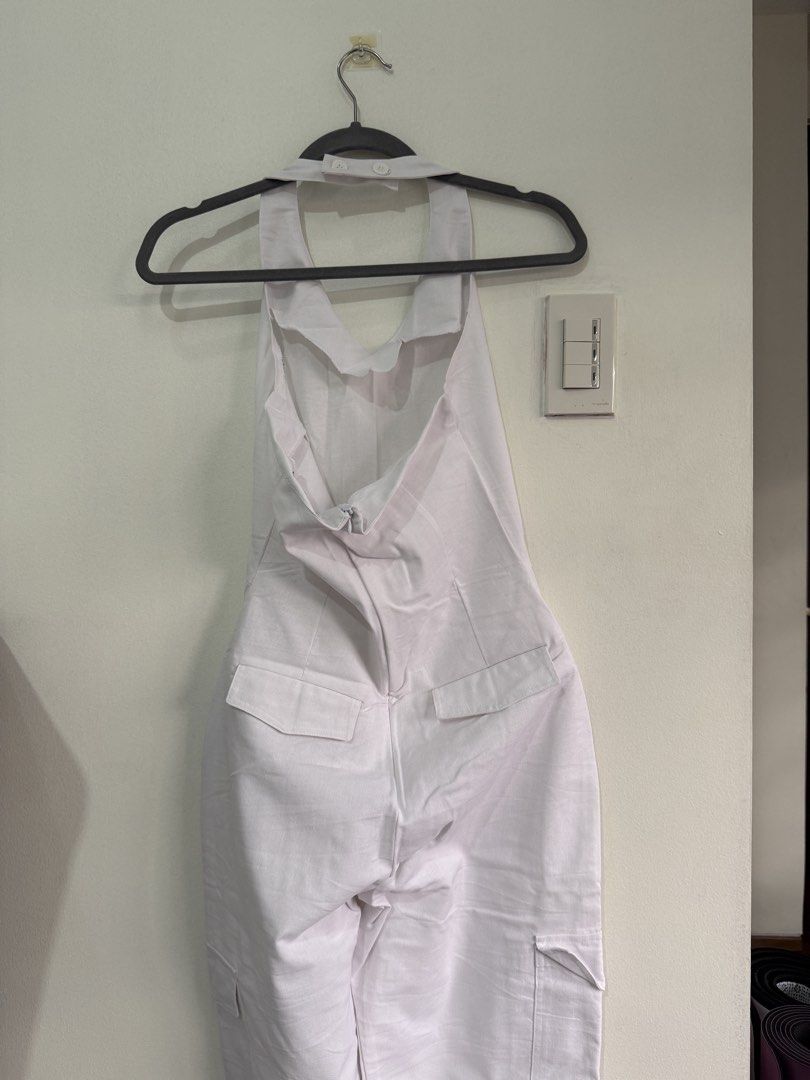 Miu The Label White Halter Neck Cargo Jumpsuit (Category: Jumpsuits) located in Muntinlupa City. Submitted by jtarchive (Listing ID 1457443729, Image 3). Description: - only worn once White halter neck jumpsuit - Back zipper closure - Adjustable neck straps - Multiple cargo pockets on legs - Comfortable and stylish for any occasion - Versatile for casual outings or evening events.