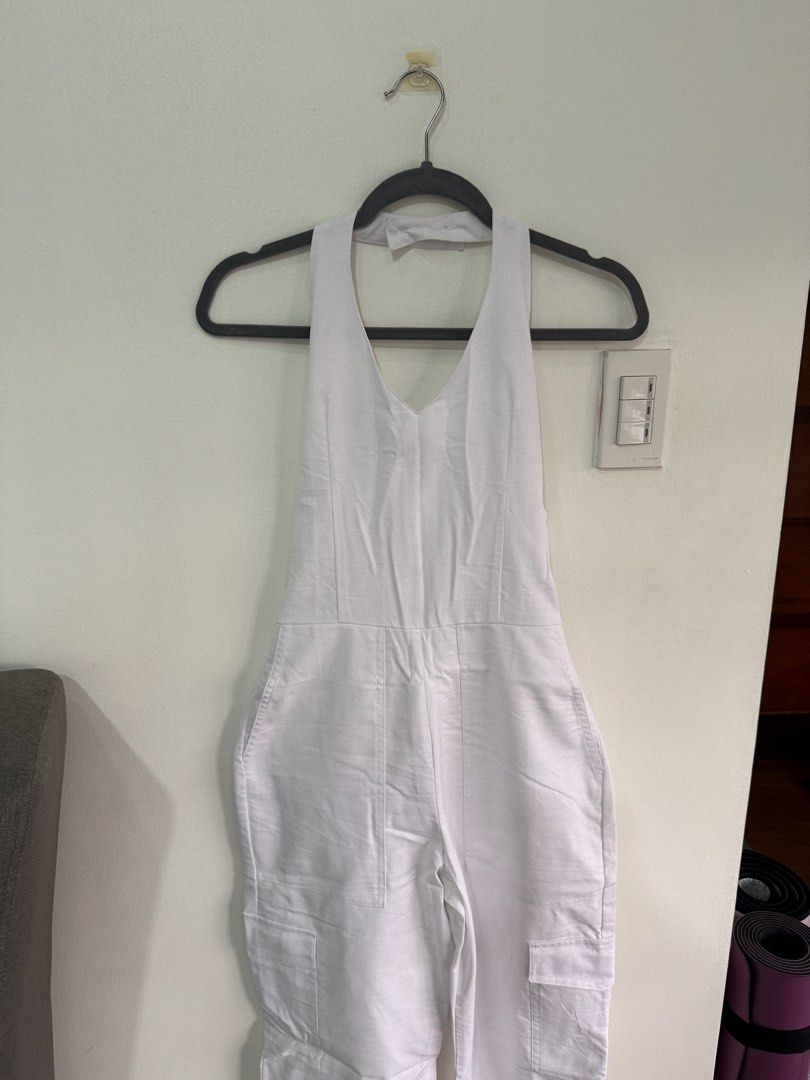 Miu The Label White Halter Neck Cargo Jumpsuit (Category: Jumpsuits) located in Muntinlupa City. Submitted by jtarchive (Listing ID 1457443729, Image 1). Description: - only worn once White halter neck jumpsuit - Back zipper closure - Adjustable neck straps - Multiple cargo pockets on legs - Comfortable and stylish for any occasion - Versatile for casual outings or evening events.