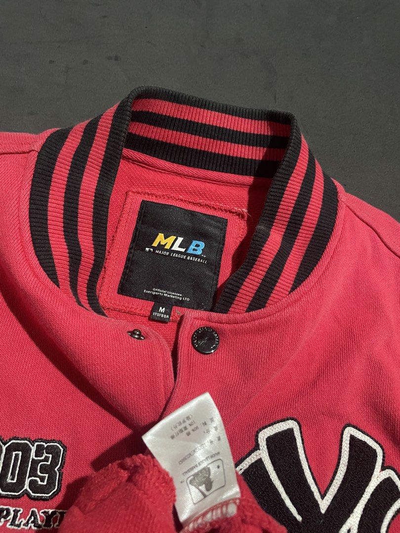 MLB New York Yankees Varsity Jacket Red M (Category: Coats, Jackets and Outerwear) located in Cebu City. Submitted by grand_kian (Listing ID 1457489308, Image 3). Description: - Red MLB varsity jacket - Features NY Yankees logo - Text: '1903 Flying Player Forever Young' - Unique patterned sleeves - Ribbed collar, cuffs, and hem - Button-up front - Size: Medium (M) - Condition: Minor marks on the front (please check photos for details).