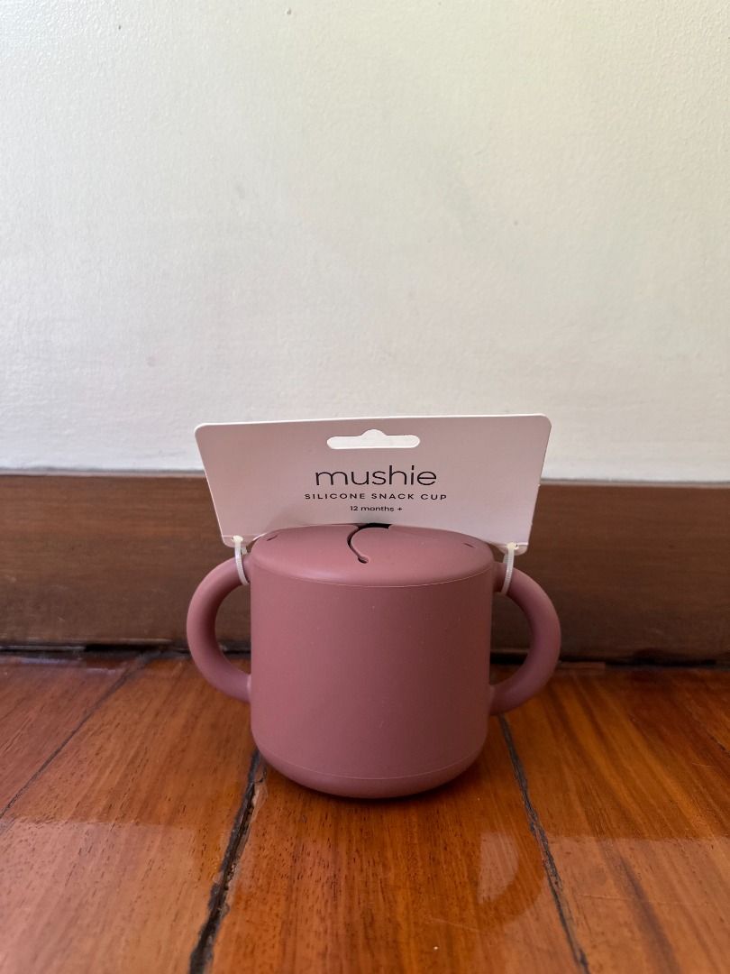 Mushie Silicone Snack Cup - Dusty Rose (Category: Weaning & Toddler Feeding) located in Makati City. Submitted by travelfinds34611 (Listing ID 1457363197, Image 2). Description: - Mushie Silicone Snack Cup in Dusty Rose - Features easy-grip handles for little hands - Lid has slits to prevent spills while allowing snack access - Ideal for babies learning to self-feed - Made from durable, easy-to-clean silicone - Perfect for snacks at home or on th