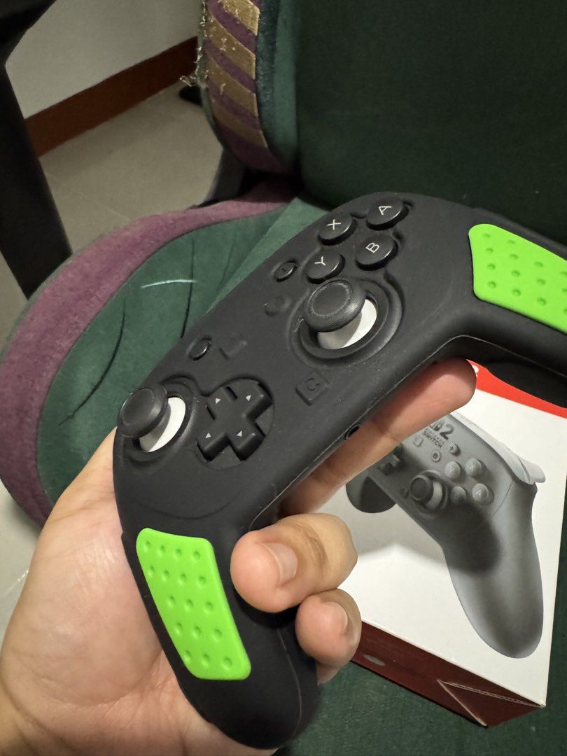 Nintendo Switch Pro Controller with Green Grips (Category: Controllers) located in San Manuel. Submitted by destram (Listing ID 1457455946, Image 2). Description: - Nintendo Switch Pro Controller - Includes original box - Comes with black silicone grip (green accents) - Works great for Switch gaming.