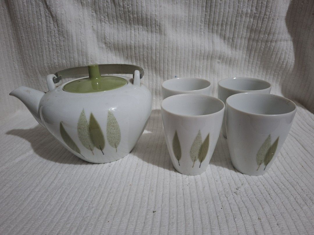 Old Noritake Wakasugi Teapot and 4 Teacups (Category: Coffee & Tea Tableware) located in Consolacion. Submitted by luxekerei (Listing ID 1457377254, Image 2). Description: - a vintage Mid-Century Modern Noritake "Wakasugi" (Young Cedar) ceramic tea or sake set featuring a white body with minimalist green leaf motifs and a distinct green lid.