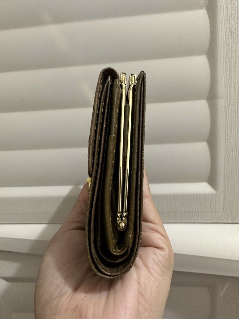 Original Ostrich GIVENCHY wallet (Category: Luxury Bags & Wallets) located in Naga. Submitted by bag.net (Listing ID 1457467881, Image 2). Description: Guaranteed original Givenchy wallet from Japan 🇯🇵 Moneyback guaranteed if proven fake This sophisticated unisex piece is crafted from khaki brown ostrich leather with smooth khaki leather accents. It features both a flap and snap button closure, with gold-tone steel hardware. Compact yet functio