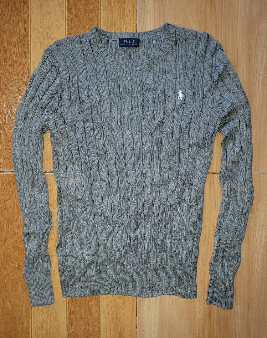 Polo Ralph Lauren Grey Cable Knit Sweater (Category: Coats, Jackets and Outerwear) located in Kabankalan. Submitted by stylesavy (Listing ID 1457383064, Image 2). Description: - Brand: Polo Ralph Lauren -w26 x L23 - Color: Grey - Material: Cable Knit - Style: Long sleeve, crew neck - Features: Signature embroidered pony logo on chest - Comfort: Comfortable and classic - Versatility: Great for layering or wearing alone.