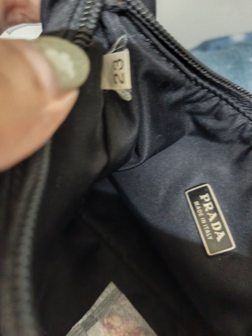 Prada Nylon Mini hobo Shoulder Bag (Category: Luxury Bags & Wallets) located in Quezon City. Submitted by zacblum (Listing ID 1457480015, Image 2). Description: y Prada shoulder bag - Black nylon material - Iconic triangular Prada logo on front - Interior Prada Made in Italy tag - Secure zipper closure - Handle shows some signs of wear - Ideal for everyday use.