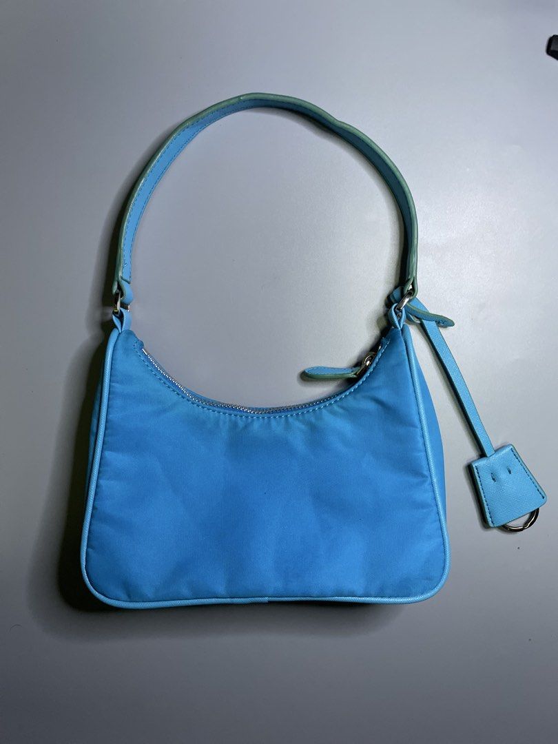 Prada Re-Edition 2005 Small Shoulder Bag (Category: Luxury Bags & Wallets) located in Bocaue. Submitted by mosthighcollective (Listing ID 1457369514, Image 3). Description: Prada Re-Edition 2005 Small Shoulder Bag Prada Re-Edition 2005 Nylon Mini Bag in bright blue features a signature enameled metal triangle logo. Good as new Condition No issue/ No flaws 5000 only Dm me to purchase 📥 .