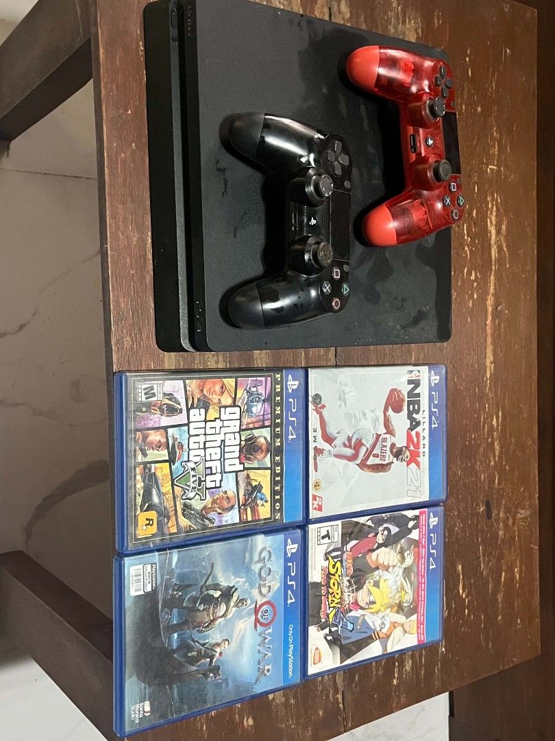 PS4 Console with 2 Controllers and 4 Games (Category: PlayStation) located in Caloocan City. Submitted by ibag.com (Listing ID 1457431839, Image 2). Description: - PS4 Console - 2 Controllers (1 Black, 1 Red) - 4 Games Included: - Grand Theft Auto V - God of War - NBA 2K21 - Naruto Shippuden: Ultimate Ninja Storm 4 - Games come in their original cases - Ready for a new home!.