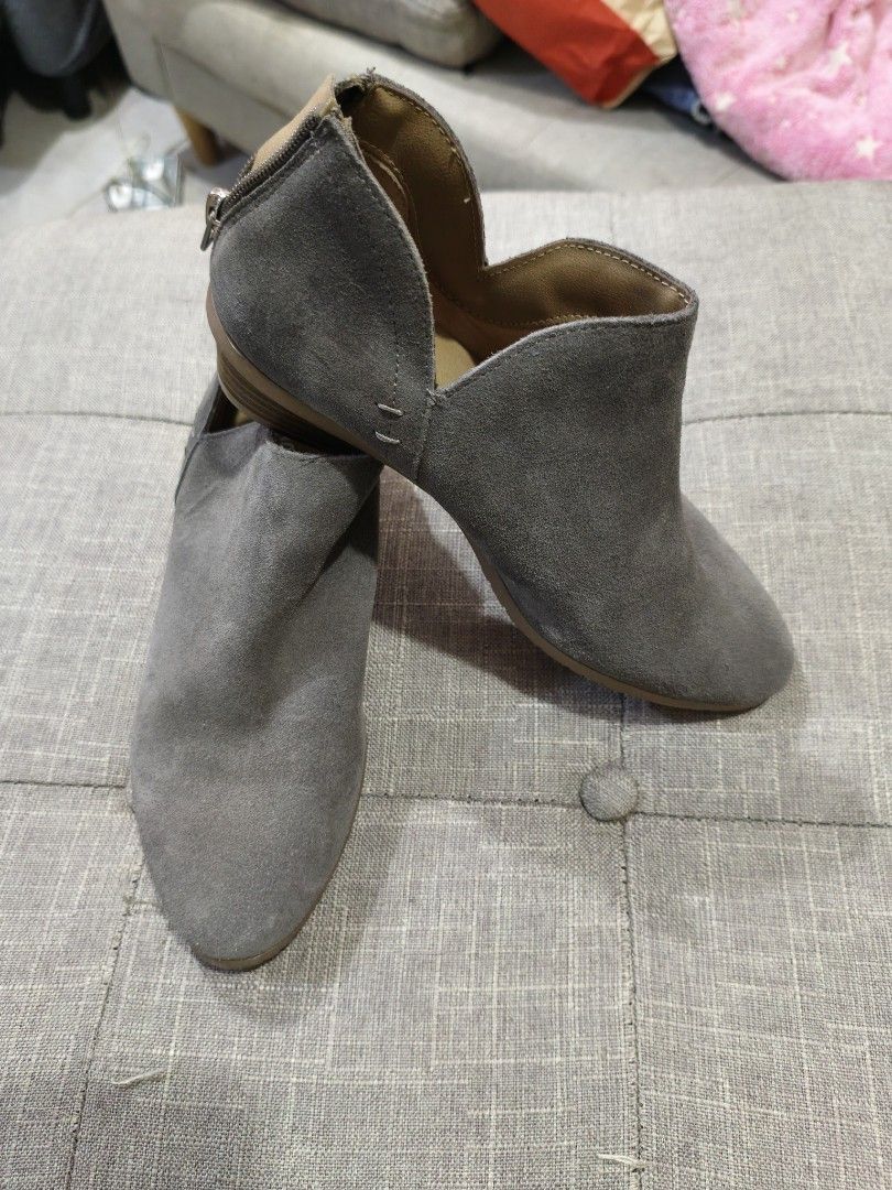Reaction Kenneth Cole Grey Suede Ankle Boots (Category: Boots) located in Marikina City. Submitted by noemitee (Listing ID 1457419462, Image 2). Description: - Grey suede ankle boots - Brand: Reaction Kenneth Cole - Side cut-out details - Back zip closure - Low heel for comfort - Versatile for everyday wear - Pairs well with jeans and dresses.