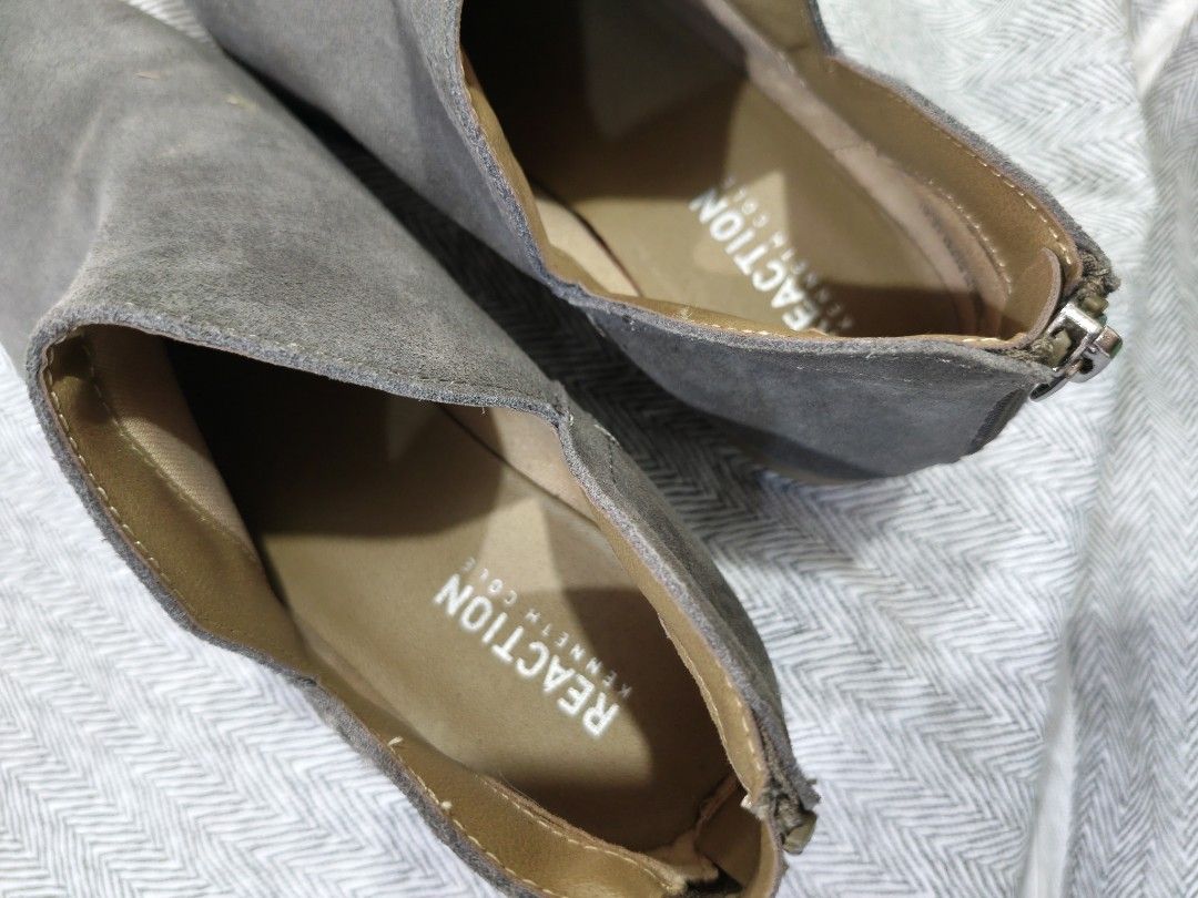 Reaction Kenneth Cole Grey Suede Ankle Boots (Category: Boots) located in Marikina City. Submitted by noemitee (Listing ID 1457419462, Image 3). Description: - Grey suede ankle boots - Brand: Reaction Kenneth Cole - Side cut-out details - Back zip closure - Low heel for comfort - Versatile for everyday wear - Pairs well with jeans and dresses.