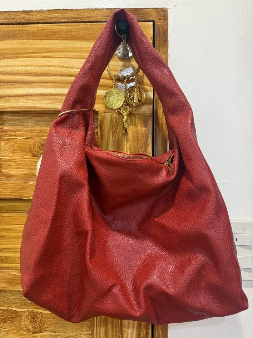 Red Leather Hobo Bag with Gold Hardware (Category: Luxury Bags & Wallets) located in Quezon City. Submitted by patchiii0416 (Listing ID 1457344491, Image 3). Description: - Spacious red leather hobo bag - Textured leather finish - Gold hardware details - Zipper closure at the top - Ample interior space for essentials - Ideal for everyday use - Versatile for various outfits.