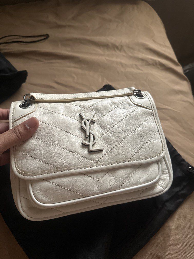 Saint Laurent White Leather YSL Monogram Chain Bag (Category: Luxury Bags & Wallets) located in Pasig City. Submitted by the_bag_agent (Listing ID 1457466615, Image 1). Description: - NGA YSL white leather bag - Elegant chevron quilting - Iconic YSL logo on the front - Chic chain strap - Interior Saint Laurent Paris stamp - Made in Italy - Comes with original dust bag and tag.