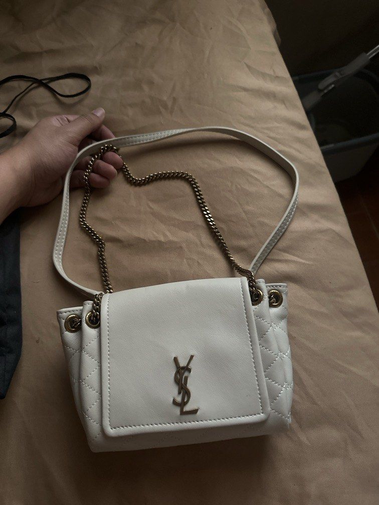 Saint Laurent White Quilted Leather Chain Bag (Category: Luxury Bags & Wallets) located in Pasig City. Submitted by the_bag_agent (Listing ID 1457468165, Image 1). Description: - NGA White quilted leather Saint Laurent bag - Elegant gold chain strap - Secure magnetic snap closure - Interior features black lining with Saint Laurent Paris logo - Comes with dust bag - Versatile for nights out or everyday wear.