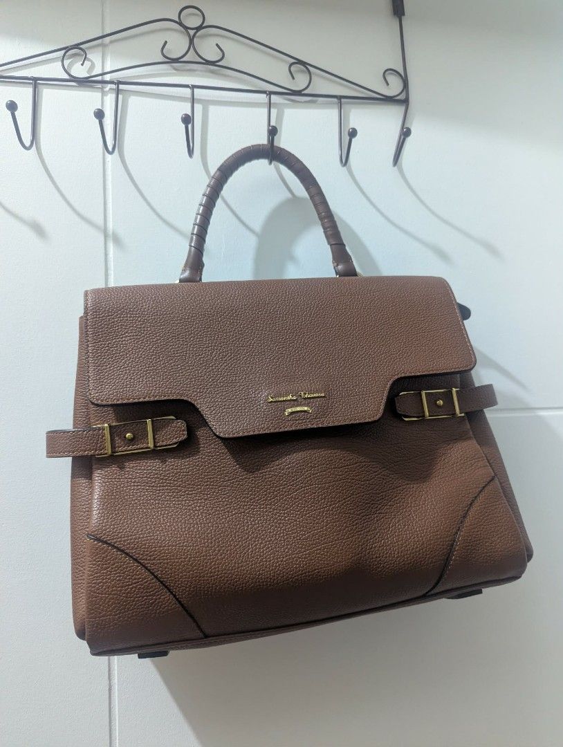 Samantha Thavasa Brown Leather Top Handle Bag (Category: Luxury Bags & Wallets) located in Pasig City. Submitted by gigigigi3366 (Listing ID 1457334212, Image 1). Description: - Brand: Samantha Thavasa - Material: Brown Genuine Leather - Features: Top handle, detachable shoulder strap - Interior: Branded fabric lining - Exterior: Buckle details on the front, gold hardware - Condition: Clean inside and out - Style: Great everyday bag no flaws, loo