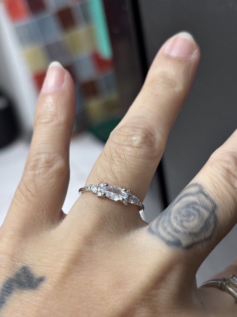 Silver engagement ring frm japan (Category: Rings) located in Quezon City. Submitted by coramalabanan (Listing ID 1457423895, Image 2). Description: This delicate white metal cluster ring features a central marquise-cut stone accented by small round brilliant side stones in a vintage-inspired arrangement Idk the materials As is frm japan Size 7 1/2.
