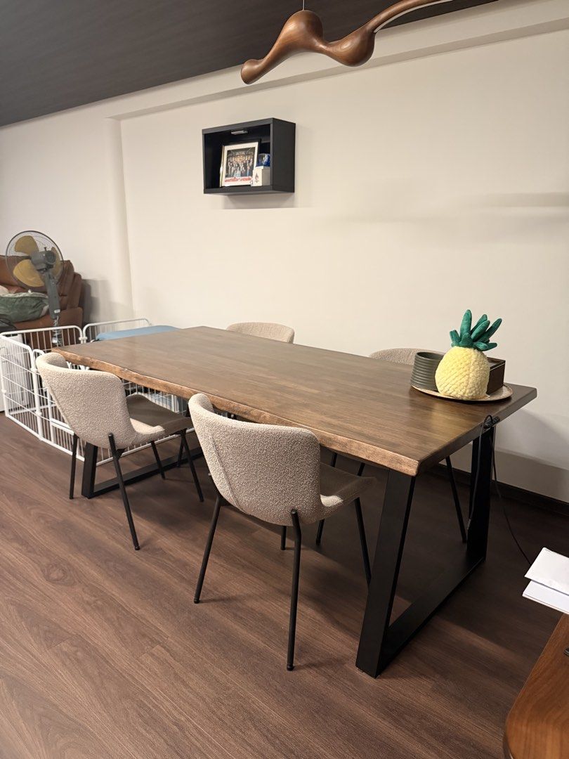 Solid Wood Dining Table (Category: Tables & Sets) located in Singapore. Submitted by makeshift_shop (Listing ID 1457482582, Image 1). Description: Solid wood dining table with a natural wood grain finish. The table has a live edge detail on one side. Great for family meals or entertaining guests. Seats 8 plush chairs comfortably..