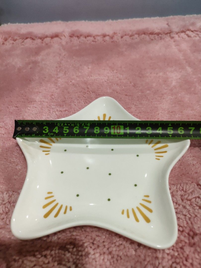 Star Shaped Trinket Dish (Category: Dinnerware & Cutlery) located in Bulacan. Submitted by hunterherojapanjdm (Listing ID 1457479413, Image 3). Description: - Adorable star-shaped dish - White with charming green dots and yellow sunburst details - Ideal for organizing small jewelry or keys - approximately 10cm across.