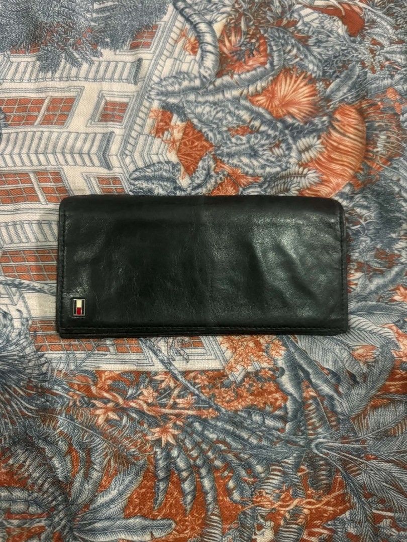Tommy Hilfiger Black Leather Long Wallet (Category: Wallets & Card holders) located in Bacolod City. Submitted by asheroth77 (Listing ID 1457461768, Image 1). Description: - Genuine black leather Tommy Hilfiger long wallet - Ample card slots and compartments for organization - Secure zippered pocket for coins or small essentials - Classic and versatile design, perfect for daily use.