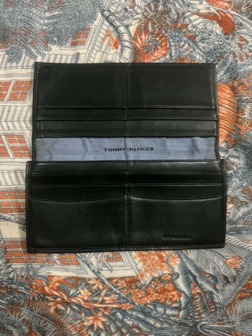 Tommy Hilfiger Black Leather Long Wallet (Category: Wallets & Card holders) located in Bacolod City. Submitted by asheroth77 (Listing ID 1457461768, Image 2). Description: - Genuine black leather Tommy Hilfiger long wallet - Ample card slots and compartments for organization - Secure zippered pocket for coins or small essentials - Classic and versatile design, perfect for daily use.