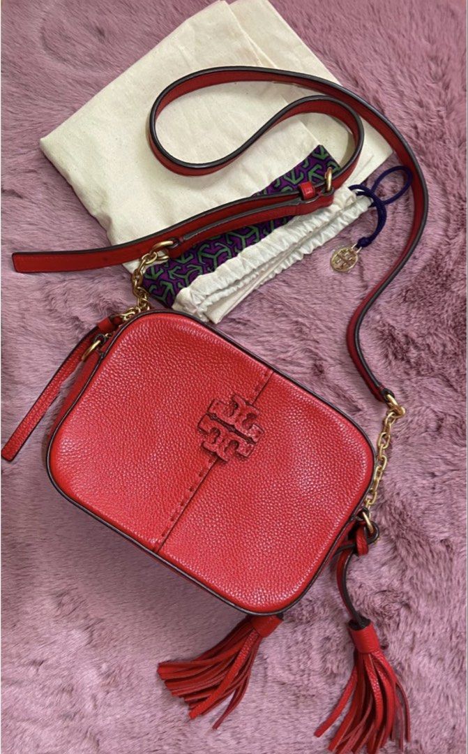 Tory Burch (Category: Luxury Bags & Wallets) located in Batangas. Submitted by aprileen (Listing ID 1457396033, Image 1). Description: Preloved Tory burch used few times 💯 Authentic - Genuine red leather crossbody bag - Elegant gold chain strap - Stylish side tassel details - Comes with original dust bag and tag - Versatile for everyday wear or evening outings - Spacious interior for all your essentials.