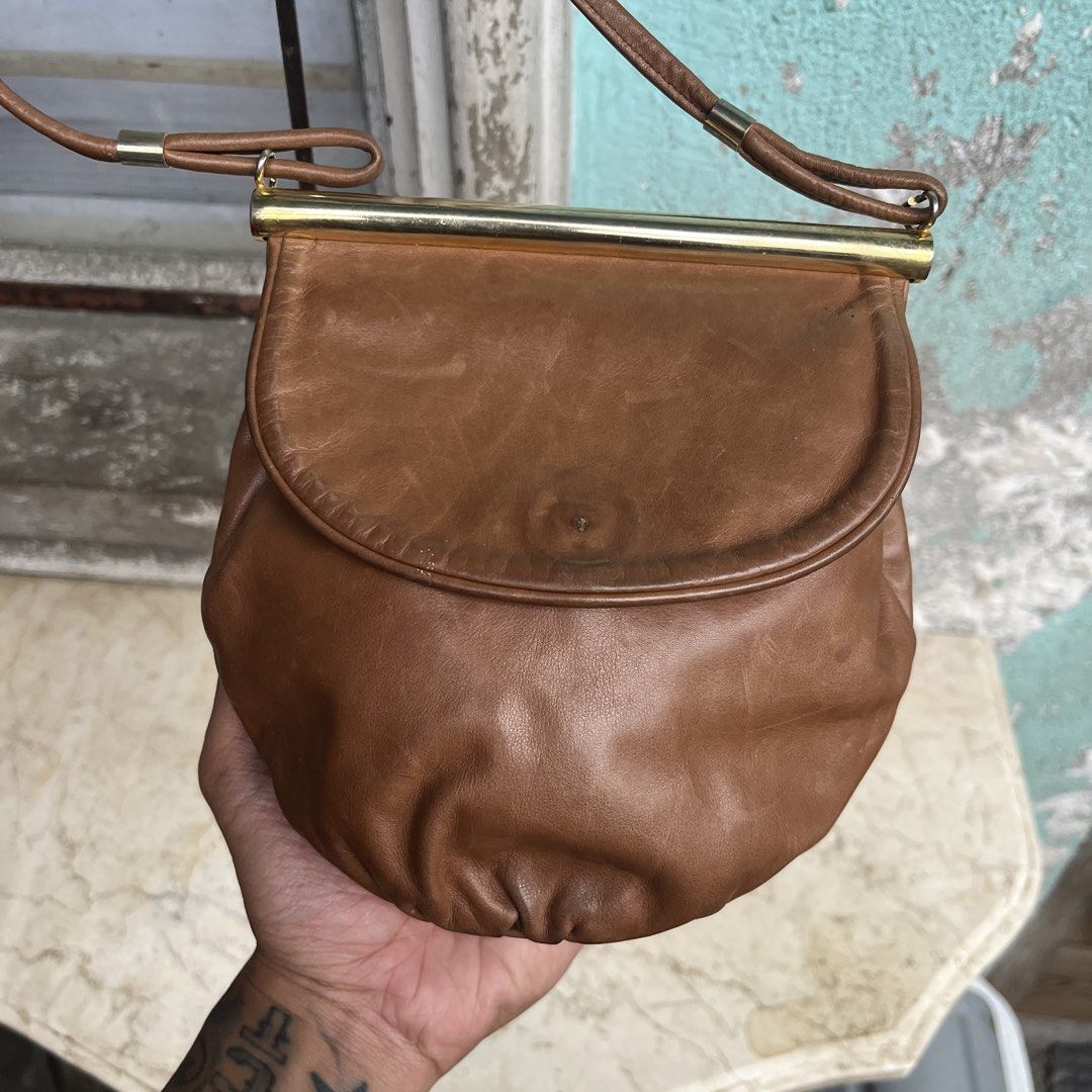 Vintage Bally Sling Bag (Category: Luxury Bags & Wallets) located in Marikina City. Submitted by wayupcollective (Listing ID 1457422016, Image 2). Description: Vintage Bally Sling Bag Genuine leather Still in good condition No flaws Measurement Length: 7” Width: 8” Depth: 3” Strap: 25” This vintage Bally piece is a beautifully preserved brown leather shoulder bag featuring a distinctive gathered pouch silhouette, a curved front flap, and an elega