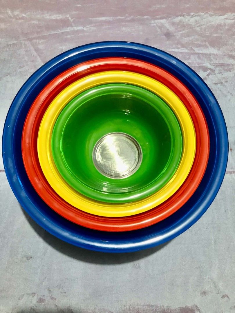 Vintage Pyrex Rainbow Nesting Mixing Bowl Set (Category: Other Kitchenware & Tableware) located in Quezon City. Submitted by goodbuyguy (Listing ID 1457348365, Image 2). Description: P3500 - 4 Piece Set Reduced to 2,800 Vintage Pyrex Rainbow nesting mixing bowls with clear glass bottoms, featuring 4 colorful bowls in blue, red, yellow, and green. Condition: Pre-owned vintage condition with normal sign of age and use. Please review all photos clos