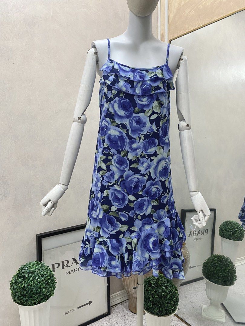 Whimsy Blue Floral Ruffle Strap Dress (Category: Dresses) located in Tanauan. Submitted by oochiecoochie (Listing ID 1457483304, Image 1). Description: Cute blue dress with a floral rose print. Spaghetti straps with ruffle detail on the neckline. Ruffle hem at the bottom. Lightweight fabric, flowy fit. Great for summer days or a casual outing..