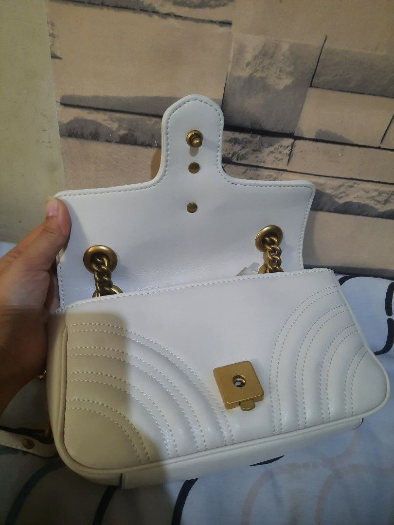 White Gucci Marmont Matelasse Mini Bag (Category: Luxury Bags & Wallets) located in San Pedro. Submitted by thriftersp47808 (Listing ID 1457407750, Image 2). Description: - Authentic white Gucci bag - Iconic quilted GG logo design - Elegant gold chain strap - Secure magnetic snap closure - Interior compartment for essentials - Versatile and chic for any outfit.