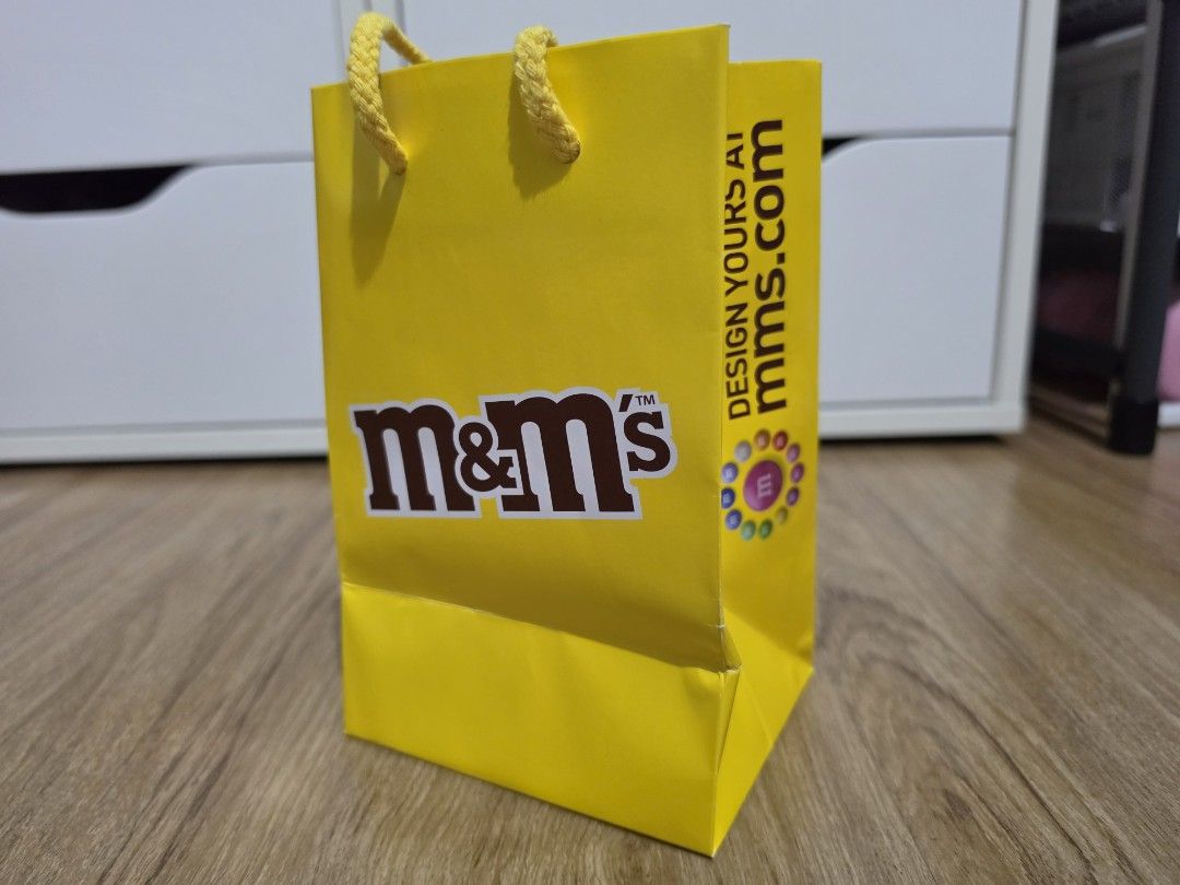 Yellow M&M's Gift Bag with Handles (Category: Craft Supplies & Tools) located in Valenzuela. Submitted by minami34 (Listing ID 1457400444, Image 3). Description: - Bright yellow M&M's gift bag - Features iconic M&M characters - Sturdy rope handles for easy carrying - Ideal for party favors or small gifts - A must-have for any M&M fan! Dimensions: (L- 11.5cm x W- 9.15cm x D - 17.85cm) Reason for selling: Declutter Note: Shipping Fee (SF) still not