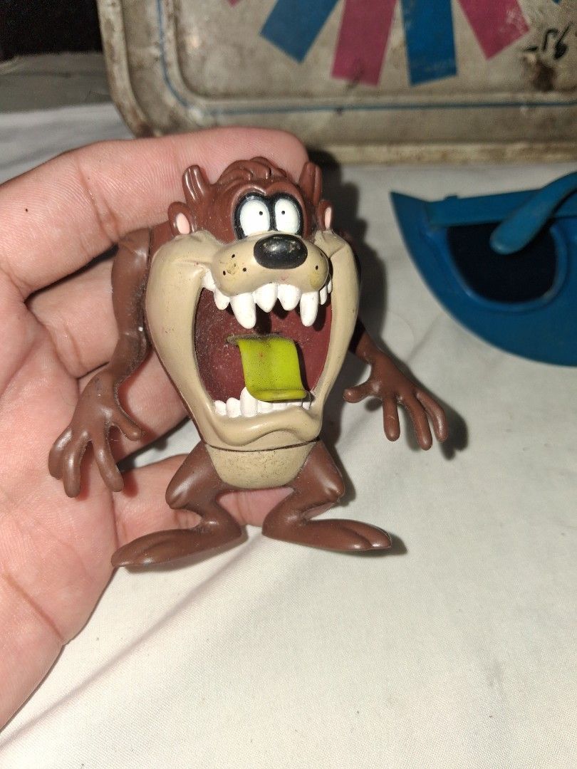 1997 Warner Bros. Tazmanian Devil Toy Figure (Category: Figurines & Statues) located in Manila. Submitted by marcas022798212 (Listing ID 1457594892, Image 1). Description: - Vintage Taz figure from 1997 - Made by Warner Bros. - Classic Tazmanian Devil collectible - Perfect for Looney Tunes fans - Brown figure with signature open mouth - Features a green item inside - Shows some signs of wear.