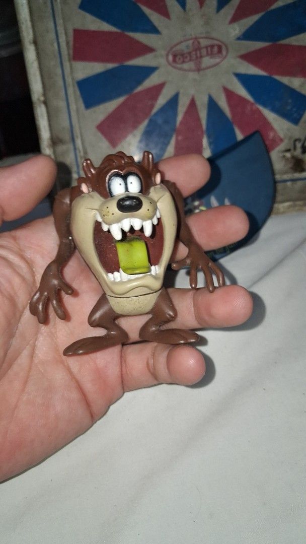 1997 Warner Bros. Tazmanian Devil Toy Figure (Category: Figurines & Statues) located in Manila. Submitted by marcas022798212 (Listing ID 1457594892, Image 3). Description: - Vintage Taz figure from 1997 - Made by Warner Bros. - Classic Tazmanian Devil collectible - Perfect for Looney Tunes fans - Brown figure with signature open mouth - Features a green item inside - Shows some signs of wear.