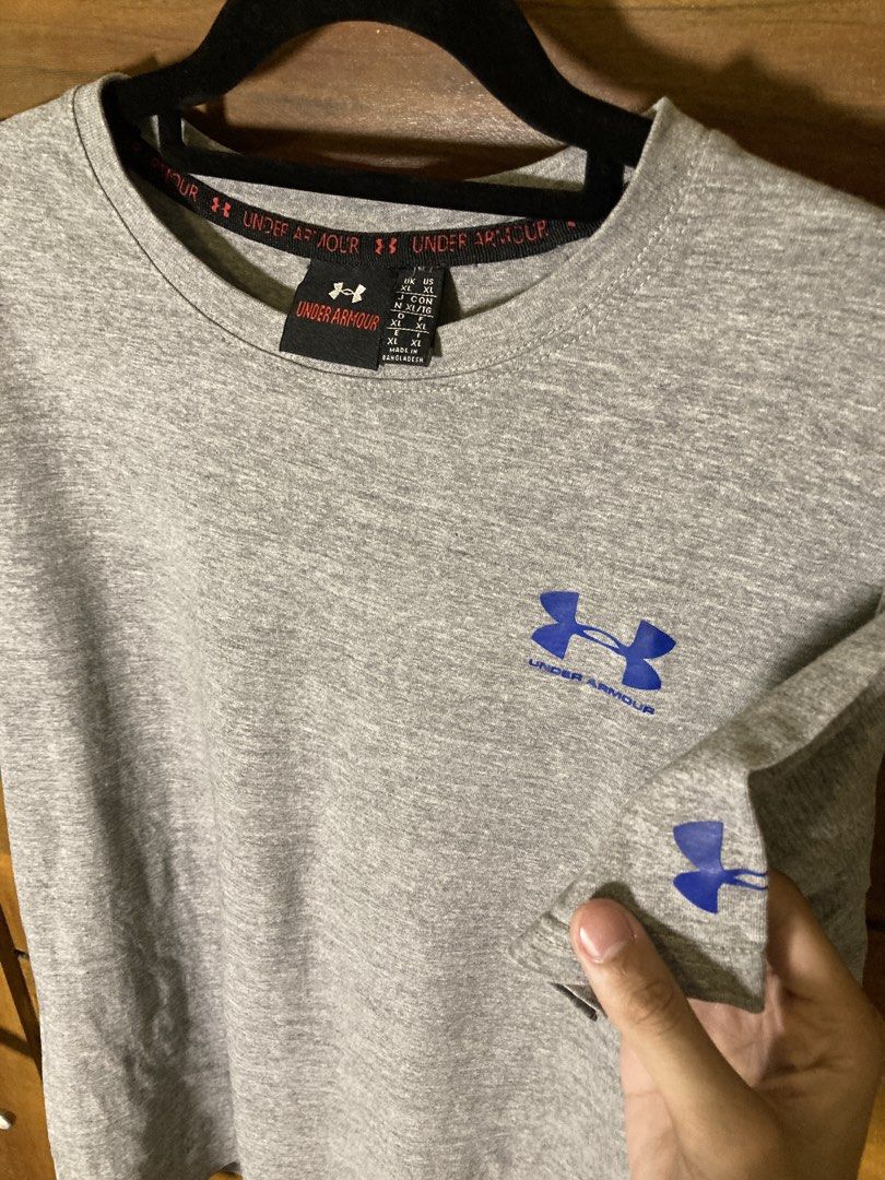 ₱10 + Shipping Fee. (Category: Tshirts & Polo Shirts ) located in Batangas. Submitted by declutteringvon (Listing ID 1457664283, Image 2). Description: - Grey Under Armour T-shirt - Features classic blue Under Armour logo on chest and sleeve - Comfortable and casual design - Ideal for workouts or everyday wear - Made in Bangladesh.