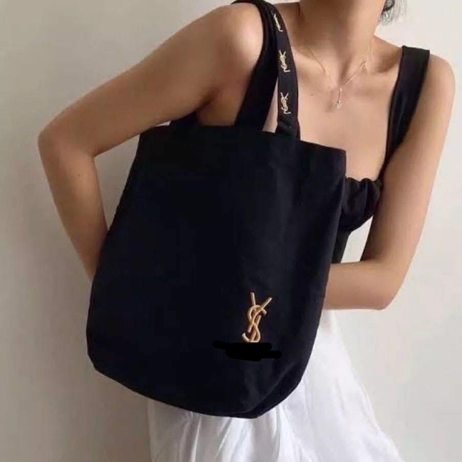 Ý$Ł Black Canvas Tote Bag (Category: Luxury Bags & Wallets) located in Mandaluyong City. Submitted by luxezvian (Listing ID 1457677287, Image 1). Description: - Stylish black canvas tote bag - Features a prominent gold Ý$ł logo - Straps have a repeating logo pattern - Dimensions: 30cm x 40cm x 12cm - Ideal for everyday use, fitting essentials like wallet, lipstick, cards, earphones, and keys.