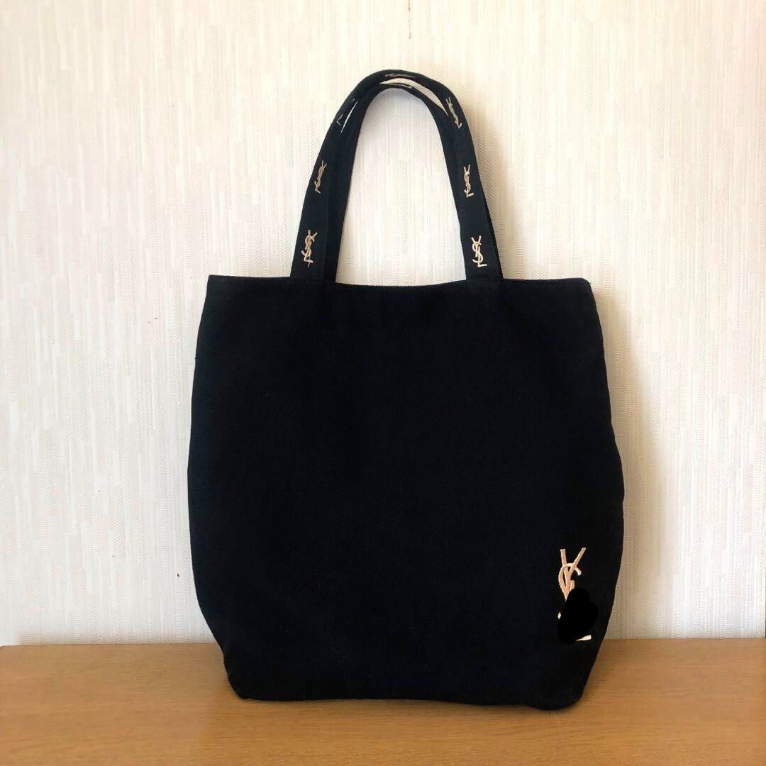 Ý$Ł Black Canvas Tote Bag (Category: Luxury Bags & Wallets) located in Mandaluyong City. Submitted by luxezvian (Listing ID 1457677287, Image 3). Description: - Stylish black canvas tote bag - Features a prominent gold Ý$ł logo - Straps have a repeating logo pattern - Dimensions: 30cm x 40cm x 12cm - Ideal for everyday use, fitting essentials like wallet, lipstick, cards, earphones, and keys.