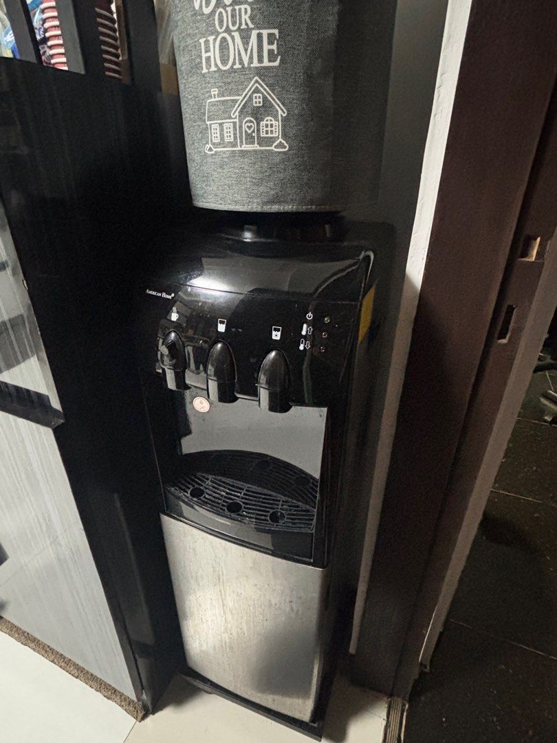 American Home Water Dispenser with Mini storage (Category: Refrigerators and Freezers) located in Quezon City. Submitted by things.matter (Listing ID 1457529983, Image 2). Description: - Pre loved American Home Water Dispenser - Hot and Cold water options - Built-in mini-fridge compartment - Ideal for kitchen or office use - Shows minor dust and scratches from normal use - Fully functional and works well ISSUE: HOT dispenser leak (pwede nyo ipafi