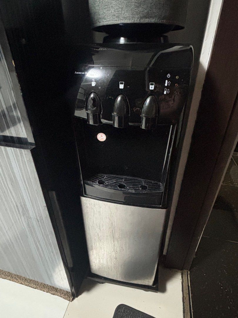 American Home Water Dispenser with Mini storage (Category: Refrigerators and Freezers) located in Quezon City. Submitted by things.matter (Listing ID 1457529983, Image 3). Description: - Pre loved American Home Water Dispenser - Hot and Cold water options - Built-in mini-fridge compartment - Ideal for kitchen or office use - Shows minor dust and scratches from normal use - Fully functional and works well ISSUE: HOT dispenser leak (pwede nyo ipafi