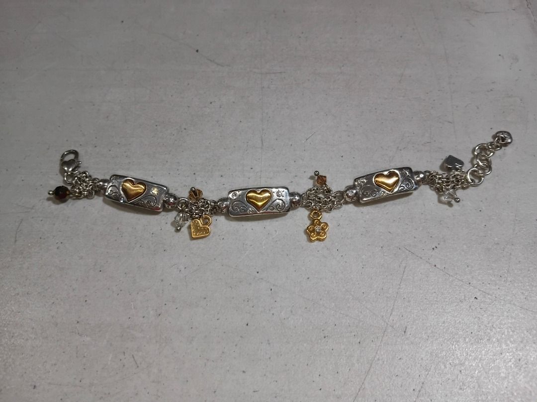 Authentic Brighton "Remember Your Heart" Two-Tone Charm Bracelet (Category: Bracelets) located in Marikina City. Submitted by my-an (Listing ID 1457655222, Image 1). Description: Authentic Brighton "Remember Your Heart" charm bracelet in pristine, like-new condition. Features heavy silver-plated link chains accented with brushed gold-toned heart tiles and dangling crystal charms. The reverse sides of the silver tiles are beautifully engraved with