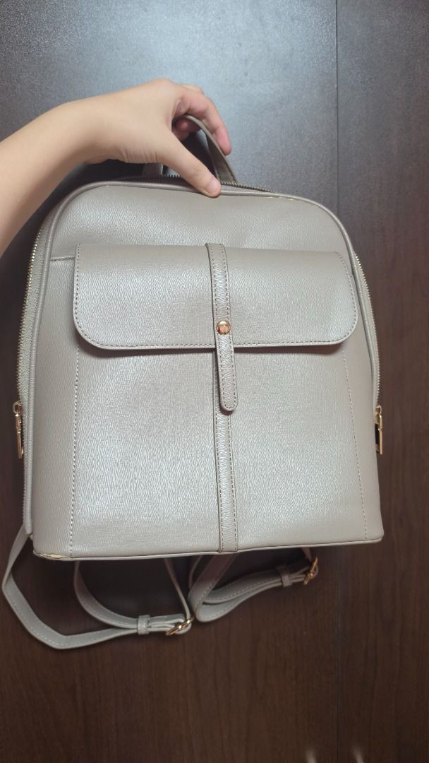 [AUTHENTIC] Miztique Grey Faux Leather Backpack (Category: Backpacks) located in Manila. Submitted by chisa05 (Listing ID 1457653917, Image 1). Description: Brand: Miztique Material: Faux Leather Features: Zipper enclosure, one three inner pockets, one outside pocket with magnetic enclosure Interior: Enough to fit a 11 inch IPad, good for school and office use NOTE: Second owner, bought from a friend, has signs of usage and peeling leather, swipe