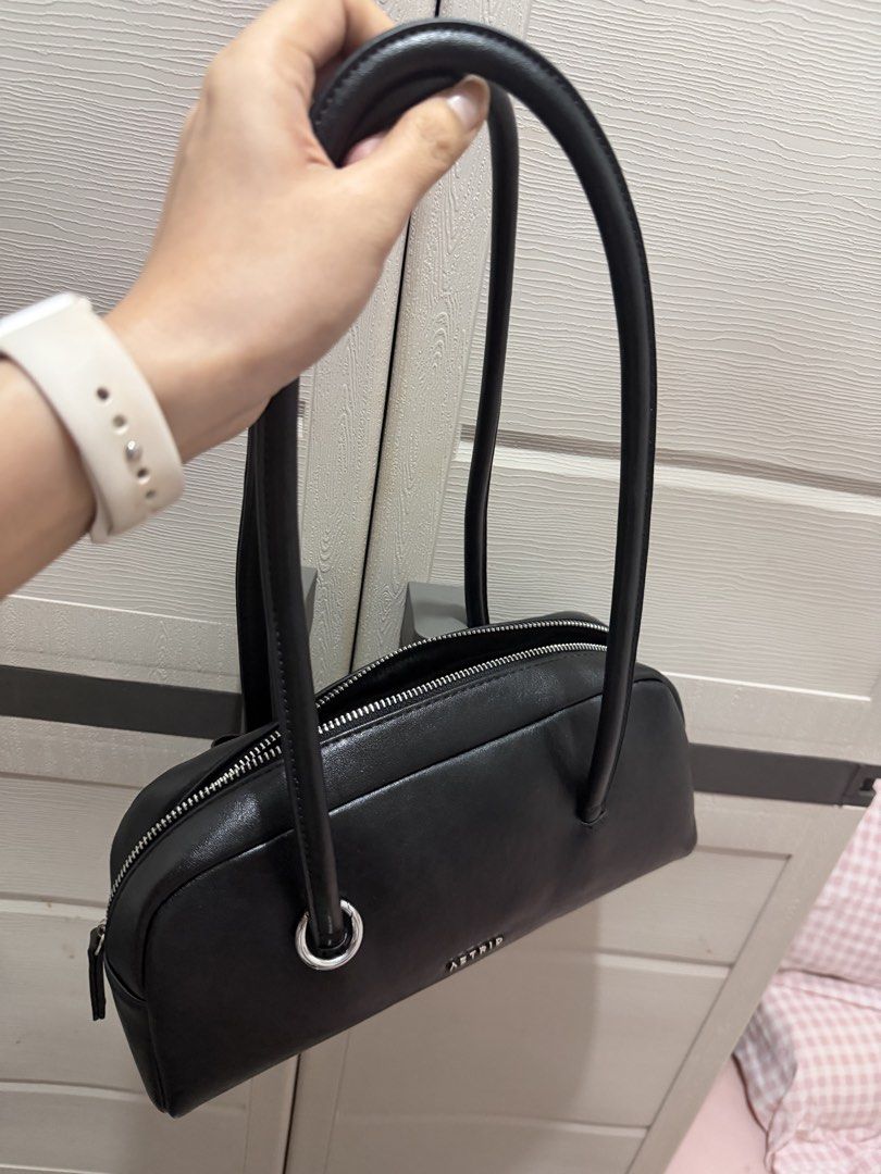 AZTRID Black Leather Handbag (Category: Shoulder Bags) located in Davao. Submitted by fabdeclutter (Listing ID 1457671844, Image 2). Description: - Brand: AZTRID - Material: Black Leather - Closure: Top Zip - Handles: Two rounded top handles - Hardware: Silver detail on the side - Style: Simple and classic - Ideal for: Everyday use.