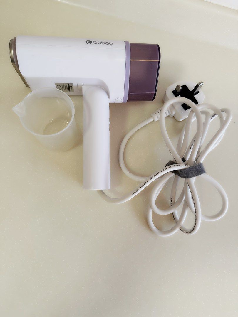 Bebay Multi-function Foldable Handheld Steamer (Category: Irons & Steamers) located in Singapore. Submitted by jestinagoh (Listing ID 1457539717, Image 1). Description: - Portable clothes steamer - Folds for easy storage - Includes measuring cup and power cord - Ideal for quick touch-ups on the go - Easy to use with an on/off switch - Compact design.