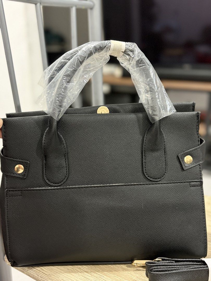 Bebe Evie Satchel Black (Category: Luxury Bags & Wallets) located in Manila. Submitted by devlisha (Listing ID 1457688916, Image 2). Description: - Brand new Black Bebe satchel bag - Detachable strap included - Elegant gold hardware details - Original tags and protective plastic on handles still attached - Size: US 1SZ .