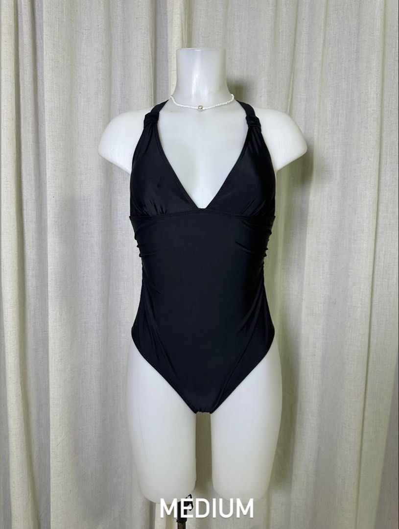 Black Halter Neck One-Piece Swimsuit - Medium (Category: Bikinis & Swimsuits) located in Baybay. Submitted by comicowl (Listing ID 1457562817, Image 1). Description: - Classic black one-piece swimsuit - Halter neck with flattering V-neckline - Comfortable and stylish - Size Medium - Ideal for beach days or pool lounging.