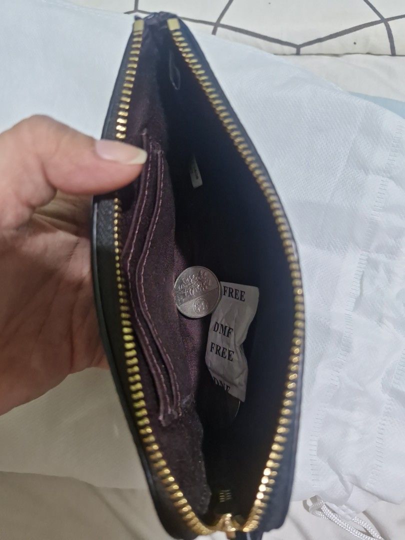 Original Coach wristlet (Category: Clutches) located in Santa Rosa. Submitted by newmoon_44fcc8 (Listing ID 1457628701, Image 3). Description: - Black pebbled leather wristlet clutch -not detachable wristlet - Small embossed logo on the front - Secure zipper closure - Ideal for carrying your daily essentials.