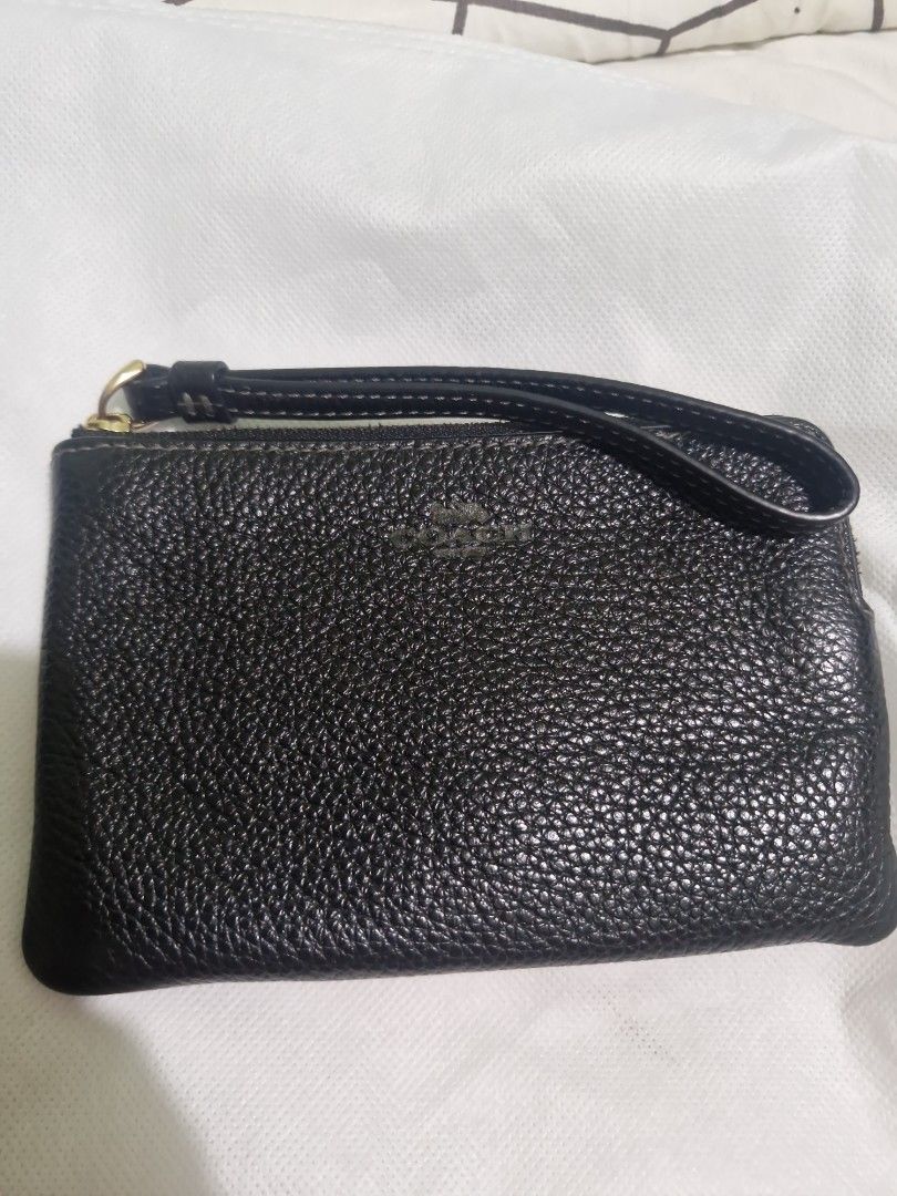 Original Coach wristlet (Category: Clutches) located in Santa Rosa. Submitted by newmoon_44fcc8 (Listing ID 1457628701, Image 1). Description: - Black pebbled leather wristlet clutch -not detachable wristlet - Small embossed logo on the front - Secure zipper closure - Ideal for carrying your daily essentials.
