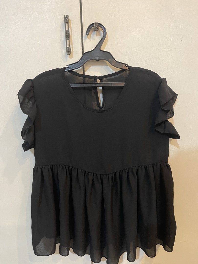 Black Ruffle Sleeve Babydoll Top (Category: Blouses) located in Santa Cruz. Submitted by lilpurpleseven (Listing ID 1457515955, Image 1). Description: - Cute black top - Flutter sleeves - Gathered waist for a flattering fit - Lightweight and flowy fabric - Button closure at the back neck - Easy to dress up or down, pairs well with jeans or skirts.