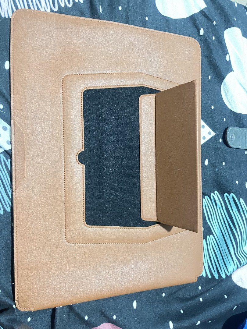 Brown Leather Laptop Sleeve with Stand (Category: Laptop Bags & Sleeves) located in Naga. Submitted by Carmel_C (Listing ID 1457662026, Image 1). Description: - Premium brown leather laptop sleeve - Integrated stand for hands-free viewing - Designed to fit most standard laptops - Convenient exterior pocket for accessories - Offers excellent protection for your device on the go - Sleek and minimalist design.